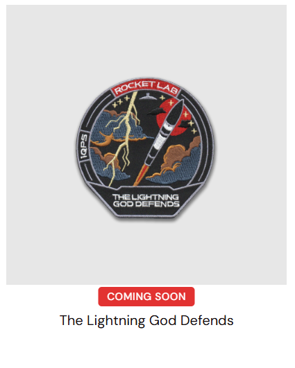 GewoonLukas_'s tweet photo. The mission patch for the next iQPS launch after "The Grain Goddess Provides" has appeared on Rocket Lab's store. The mission is named "The Lightning God Defends". The colors of the patch seem to match with the sticker on this fairing, so we could see back-to-back iQPS launches. https://t.co/ipPnVzoF0A