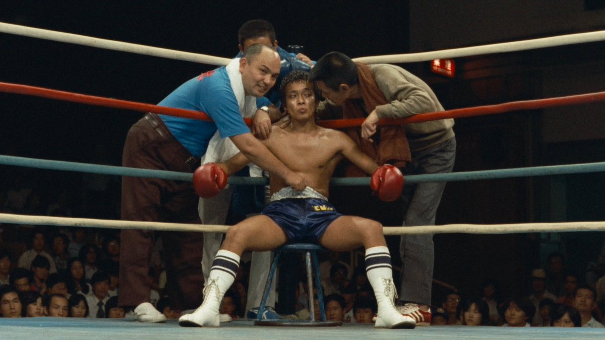 TimesSqKungFu's tweet photo. The Boxer ボクサー [1977]
Directed By: Shuji Terayama

Talk about a film that sets the tone from the very start. The walk in the tunnel before the match begins with this haunting track playing and the fighter walking by a batter boxer and when he gets in the ring, before the match you get a tribute to a fallen boxer from the announcer. 

You get the sense of dreed already and then an unfortune event happens. A film coated with these faded but beautiful colors which is not uncommon from the director paints this world of grinding but the ways the colors are used is like there is still a glimmer of hope.

With characters mentality or physically beaten you get all forms of metaphorical signs that relates to the main cast. Not a pretty world and the surroundings reflect the characters with a sense of mystery because throughout the film once you know Bunta's past (Hayato) on why he walked away from the sport or why he decided to train this young man (Considering what he is connected to and what he did) The "why" becomes the overall theme Hayato's actions.

Very amazing addition to the @FilmsRadiance library and is a film I'm still thinking about now since I saw it for the first time years ago and revisiting this Blu-Ray love it more than I already did. With a great training montage an interesting characters with one heck of a finale. I highly recommend it. 

This comes out on July 21th via @mvdentgroup 
https://t.co/k8YJSKNK3q