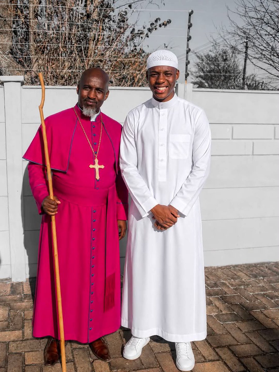 Gwani_bukhari's tweet photo. I was born in the Zion Church.

My father is a bishop, and for many years, that was the only path I knew. It was the faith of my parents, my grandparents, and my community.

But Allah, in His infinite mercy, guided me to Islam.

This picture tells the story of two journeys. My father standing in the faith he has known all his life, and me standing upon the faith that Allah guided me to.

A few days ago, my father did something that touched me deeply. He drove all the way to see me without telling me he was coming, simply to collect an English and isiZulu Qur’an that I had arranged for him as a birthday gift. I only realized he was there when he arrived.

As I handed him the Qur’an, I couldn’t help but reflect on the wisdom of Allah. I never imagined that one day I would be the first Muslim in my family, handing the Book of Allah to my own father.

I was the first in my family to hold the Qur’an.
The first to say:

“La ilaha illallah, Muhammadur Rasulullah.”

Islam started with me in my family, but by the permission of Allah, I pray it does not end with me.

 This is very commendable, I have full respect for this father for upholding the freedom of religion.