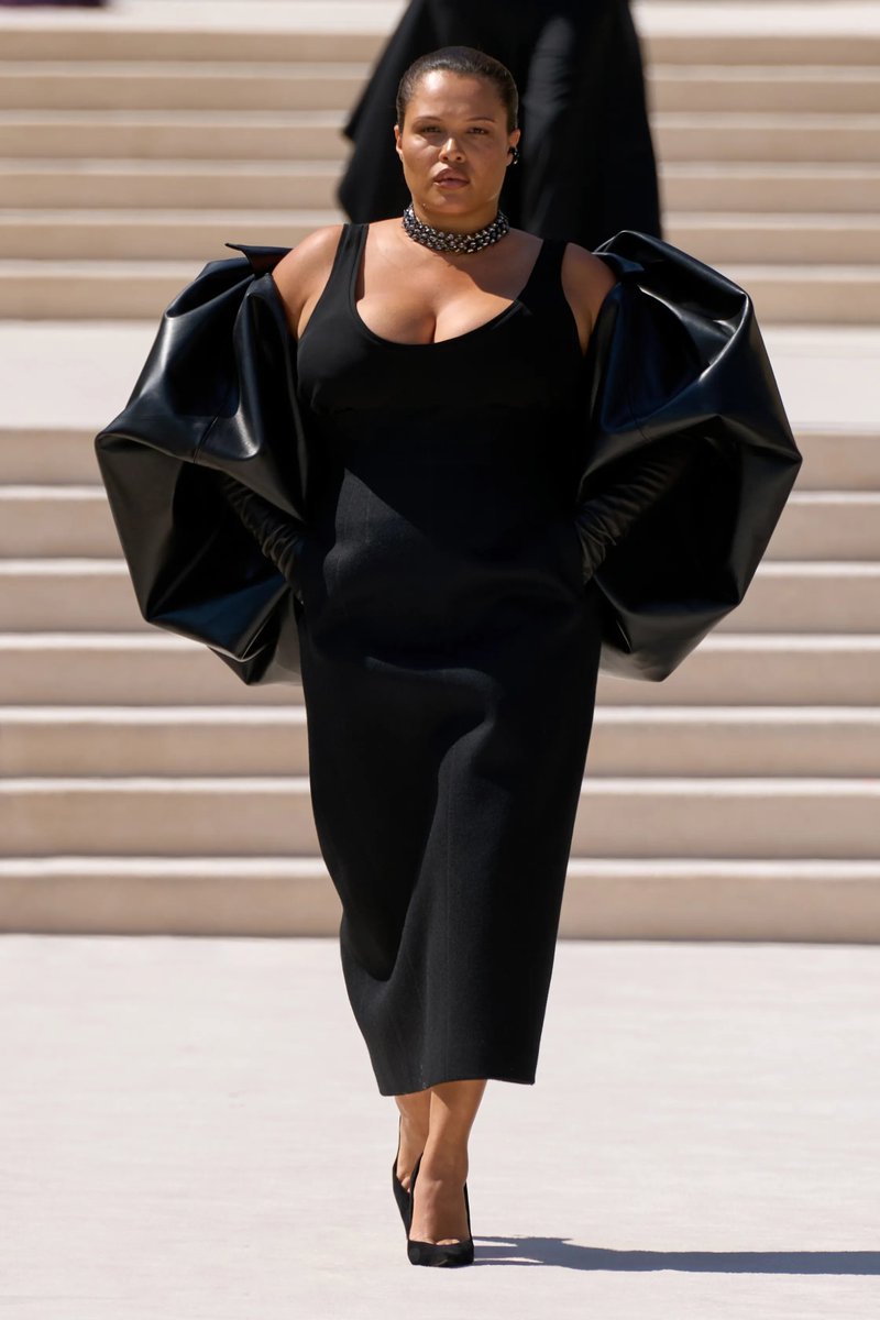 itsbleekerxox's tweet photo. This is Alva Claire &amp; she's in more than a "simple plain tank dress w/ a voluminous accessory". She's a plus sized black woman in a Cristobal Balenciaga 1959 couture staple bubble cape couture historical silhouette. We need to look at context in full before our upsets! https://t.co/7JWF9y0Ota