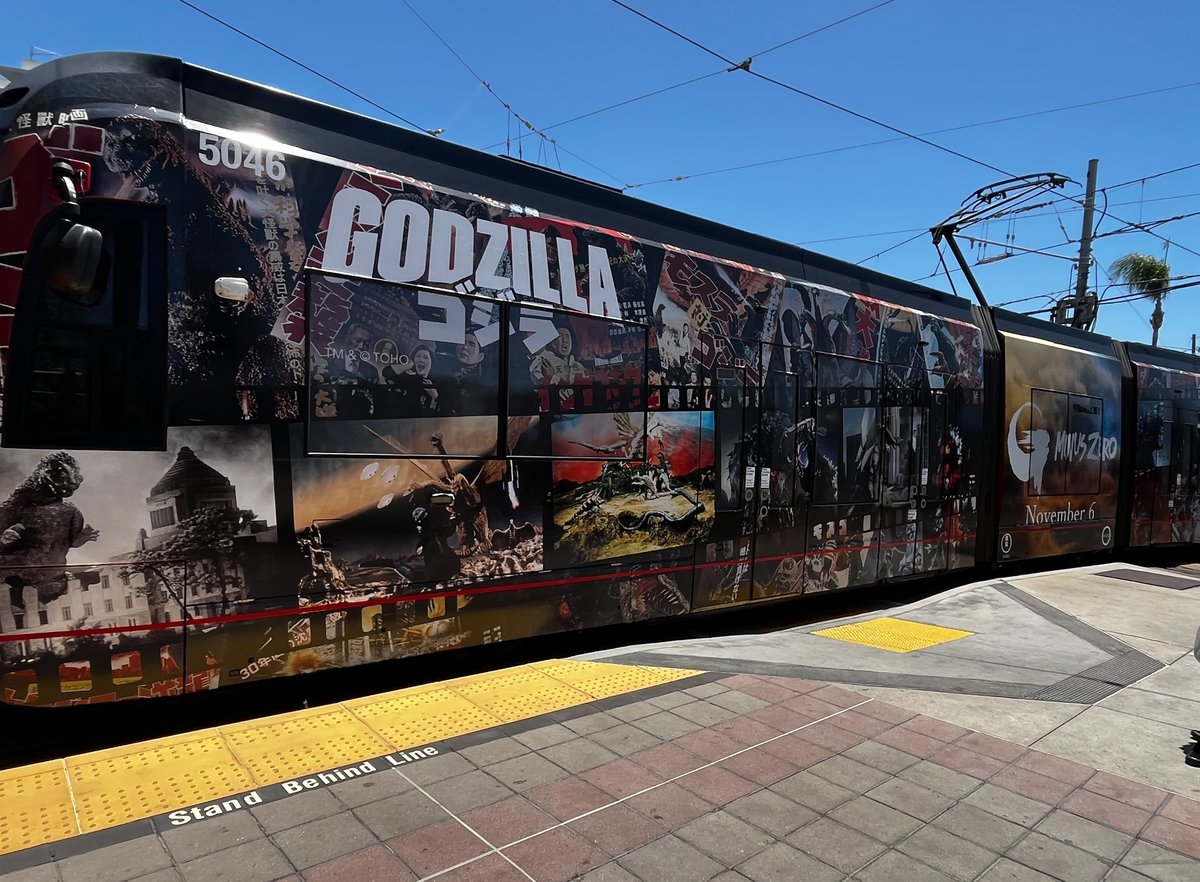 SD_Comic_Con's tweet photo. #Godzilla is roaring into #SDCC with a new @sdmts trolley wrap from @BandaiCollect, which also features #GodzillaMinusZero... More via our own @OutsideComicCon: https://t.co/iafCTtk5fP https://t.co/lpoQavo1Kj