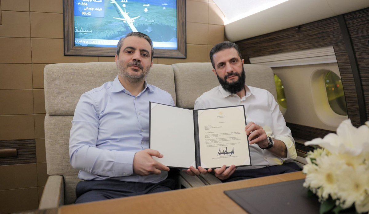 Charles_Lister's tweet photo. #Syria's President al-Sharaa (@AH_AlSharaa) &amp; Foreign Minister al-Shaybani (@AsaadHShaibani) holding a letter shared by President #Trump earlier today.

The SST will soon be gone, and in #Trump's words, American companies lie in wait to invest. https://t.co/OqQjdFxEWj
