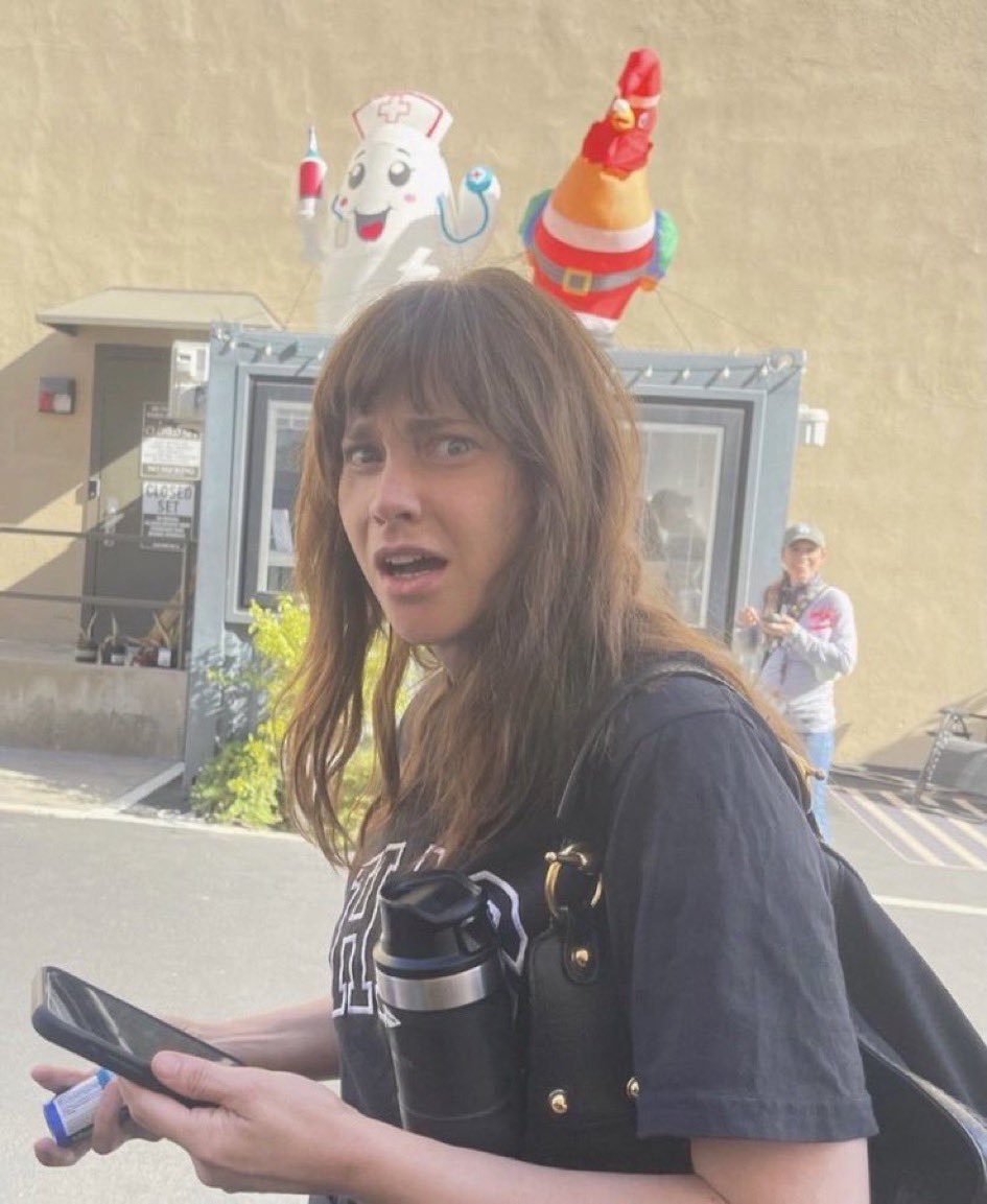 shinypugh's tweet photo. hag shirt and a big ass bag at least she's not carrying the red water tank https://t.co/rVmXS4sZzl
