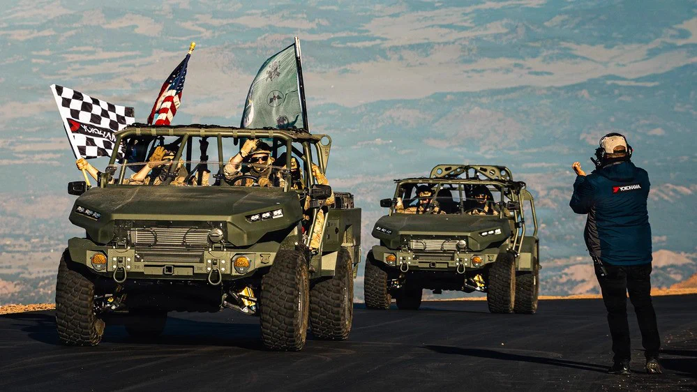 10th Special Forces Group (Airborne) Soldiers deliver the checkered flag to race officials during the Pikes Peak International Hill Climb race in Colorado Springs, Colo.\n