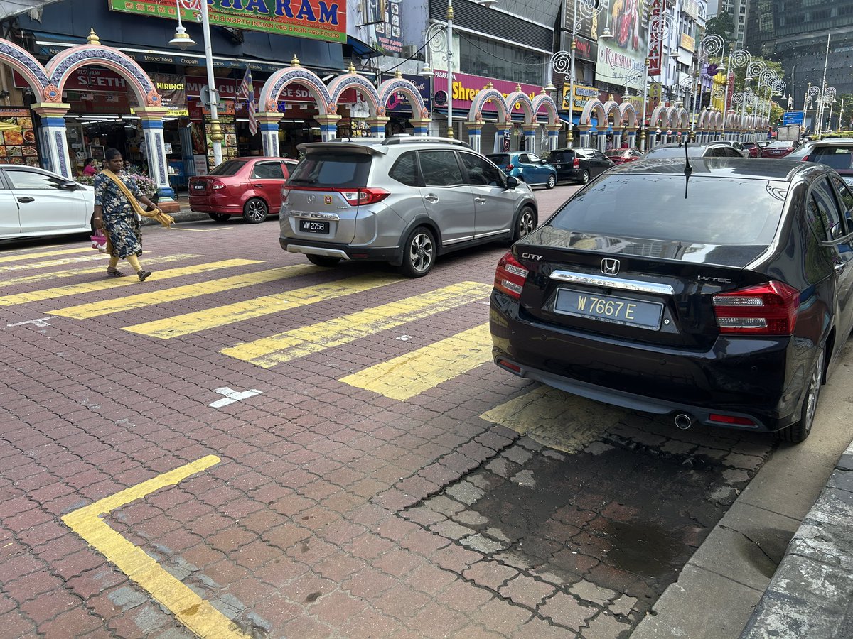 amirulruslan's tweet photo. KL logic: the zebra crossing for pedestrians is literally blocked by parking. Not illegal parking. An actual box. https://t.co/ZmK7UP3vex