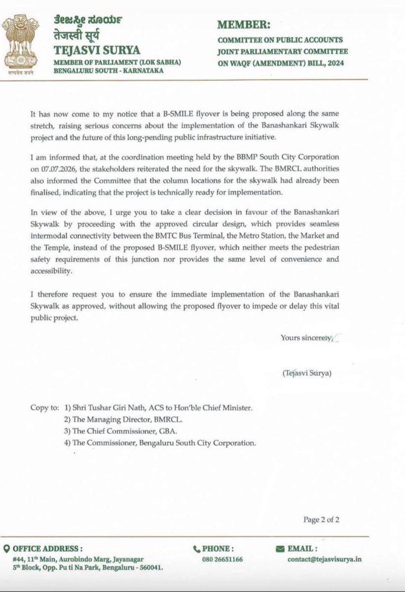 Tejasvi_Surya's tweet photo. A few weeks ago, an elderly woman lost her life while trying to cross the road at Banashankari. It was another tragedy that could have been prevented.

For nearly seven years, I have fought to get the Banashankari Skywalk built. We got a practical, commuter-friendly circular design prepared so people would actually use it. We secured ₹45 crore in the BBMP Budget. The foundation stone was laid. Yet, despite all this, the project has not even begun.

Should it really take this many years to build a simple skywalk?

I have once again written to Bengaluru Development Minister @krishnabgowda, requesting him to ensure that the approved Banashankari Skywalk is taken up immediately and not replaced by a proposed B-SMILE flyover that cannot provide the same level of pedestrian safety, accessibility and seamless connectivity between the TTMC, Metro Station, Market and Temple.

I remain hopeful that the Minister will personally intervene and finally make this long-pending public safety project a reality.

Bengaluru must put people before road projects. Every delay puts more lives at risk.

@GBAChiefComm 
@OfficialBMRCL