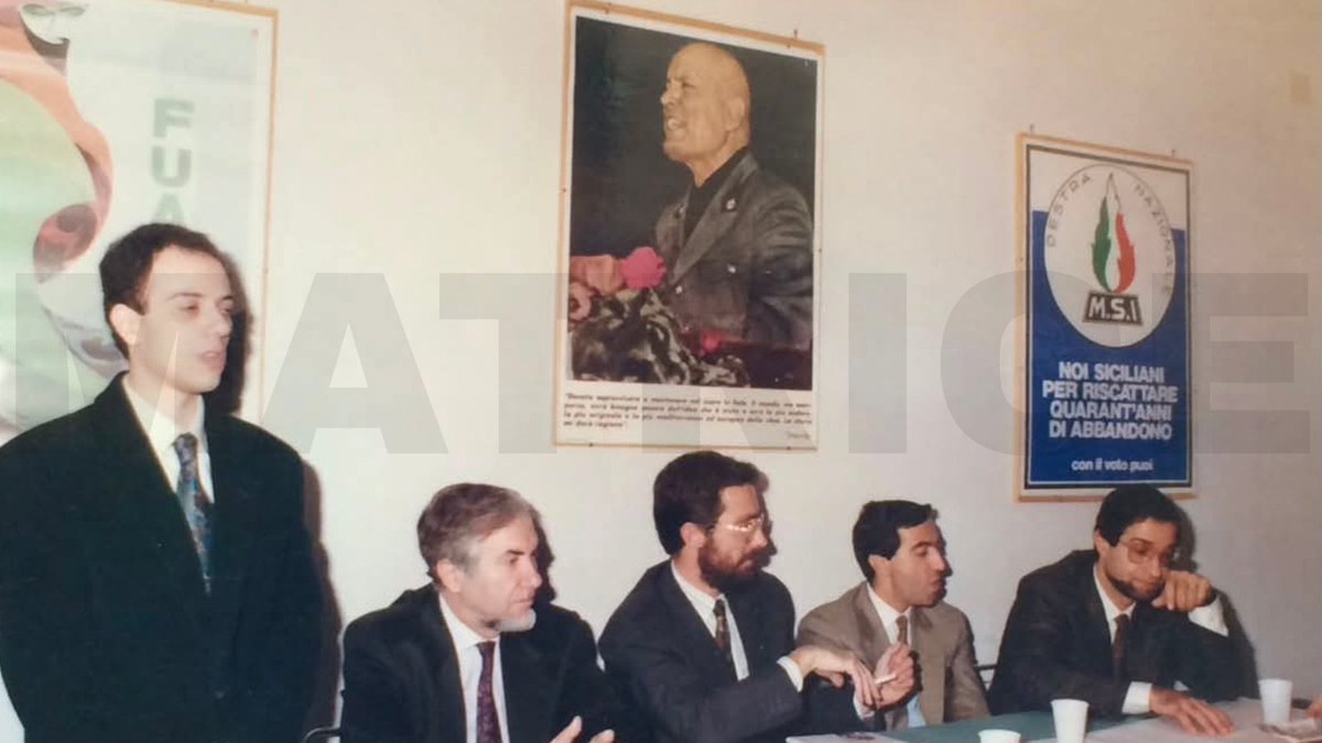AlekosPrete's tweet photo. Catania, 1987. Inaugurazione della sezione MSI intitolata a Ramelli. Al tavolo dei relatori, sotto l’effigie di Benito Mussolini, siedono i giovani camerati Maurizio Gasparri e Nello Musumeci (oggi ministro della Repubblica). Altro che "spauracchio" della sinistra. #matrice https://t.co/01juS8prsZ