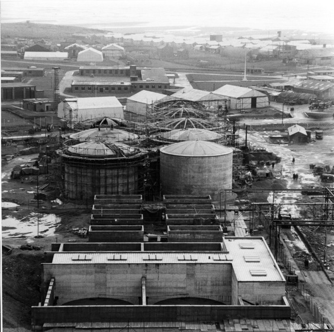 SellafieldLtd's tweet photo. For this week's #ThrowbackThursday, we're turning back the floc… ⏮️

These storage tanks date back to the 1950s and contain complex radioactive sludge, known as floc, created as a byproduct of early reprocessing operations .

Originally outside, the tanks were later enclosed within a specially designed overbuilding to help protect their integrity and support the installation of retrievals equipment. Steel jackets were also added to provide further protection.

At the time, the floc tank overbuilding was the largest moveable structure in the world.

Can you remember what year the overbuilding was constructed? Drop your guesses in the comments below! 👇

And keep your eyes peeled tomorrow for an update on the progress we're making with floc retrievals from these legacy storage tanks.

#ThrowbackThursday #TBT #Sellafield #Engineering #NuclearHistory