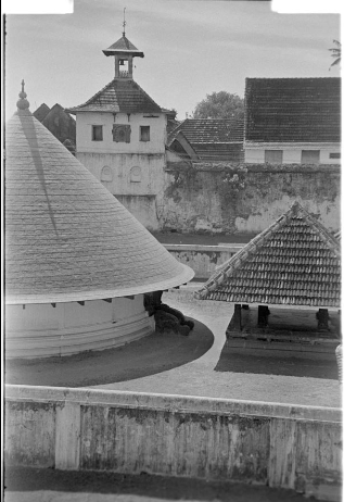 SOAS_SpecColl's tweet photo. This photograph, taken by Christoph von Fürer-Haimendorf, probably of the town of Cochin, shows an interesting mixture of architectural styles. The conical roof of the early Kerala temple is set against the tower of a colonial building and other roof tops. #EYAArchitecture https://t.co/qlqMViZaWX