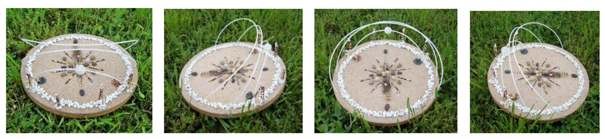 Four pictures of a sun track model, shown from different angles. The model is a flat, round surface with small pebbles surrounding the edge and a starburst shape in the center. Rising up from the edges are three arches representing the path the Sun takes across the sky at three different points during the year.