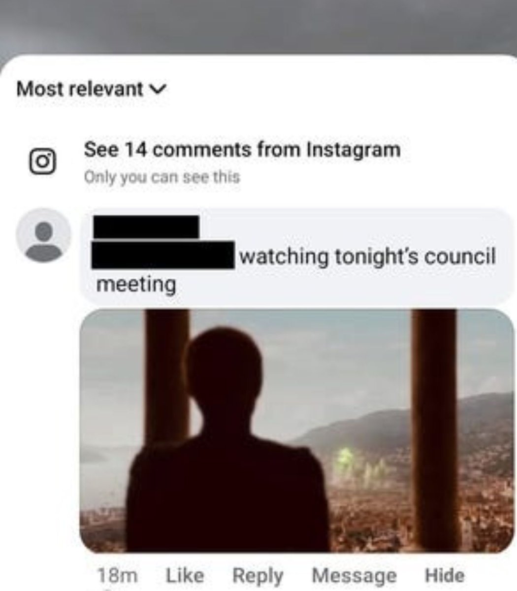 Redacted screenshot of a Facebook comment showing a silhouette overlooking a city with a faint green glow, captioned watching tonight's council meeting