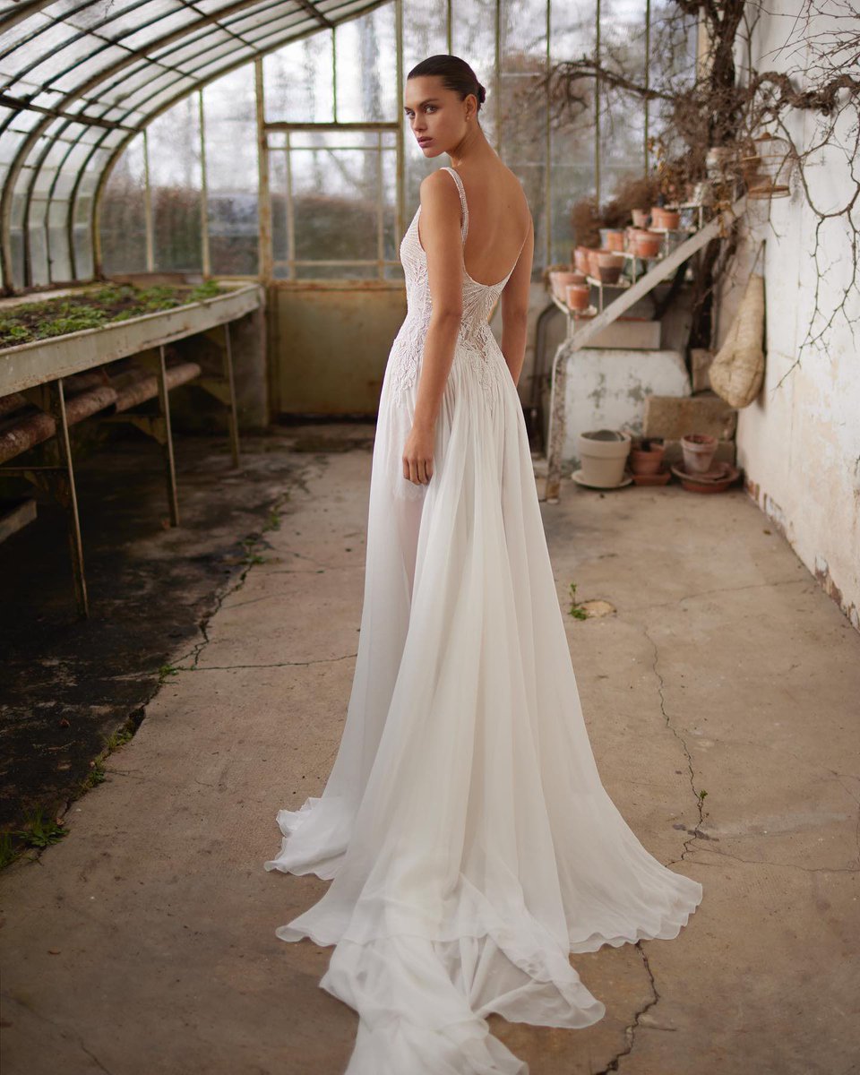 vogueishgirl's tweet photo. This Dana Harel "Luna" wedding gown features an intricately beaded bodice and a flowing crepe silk chiffon skirt with a high leg slit https://t.co/iDkarotCCd