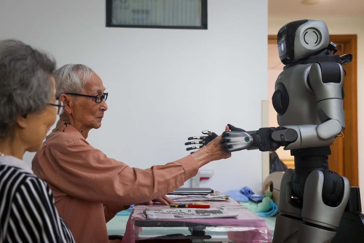 thisisGBA's tweet photo. 🤖💗 When a robot checks your vitals.

A humanoid robot is now being tested at a senior care home in Shenzhen. It moves through the halls autonomously and helps elderly residents check their heart rate and blood oxygen levels simply by touching its fingertip.
In this heartwarming moment, Grandma Chen and Grandpa Yang gently press their fingers against the robot's fingertip, and about a minute later, the robot reads out their vital signs.
Tech with a human touch. That's the future we want to see.

📍 Shenzhen, China
🗓️ July 2026

#Robotics #AI #HumanoidRobot #ElderlyCare #HealthTech #Shenzhen #Innovation #TechForGood #FutureIsNow #ChinaTech