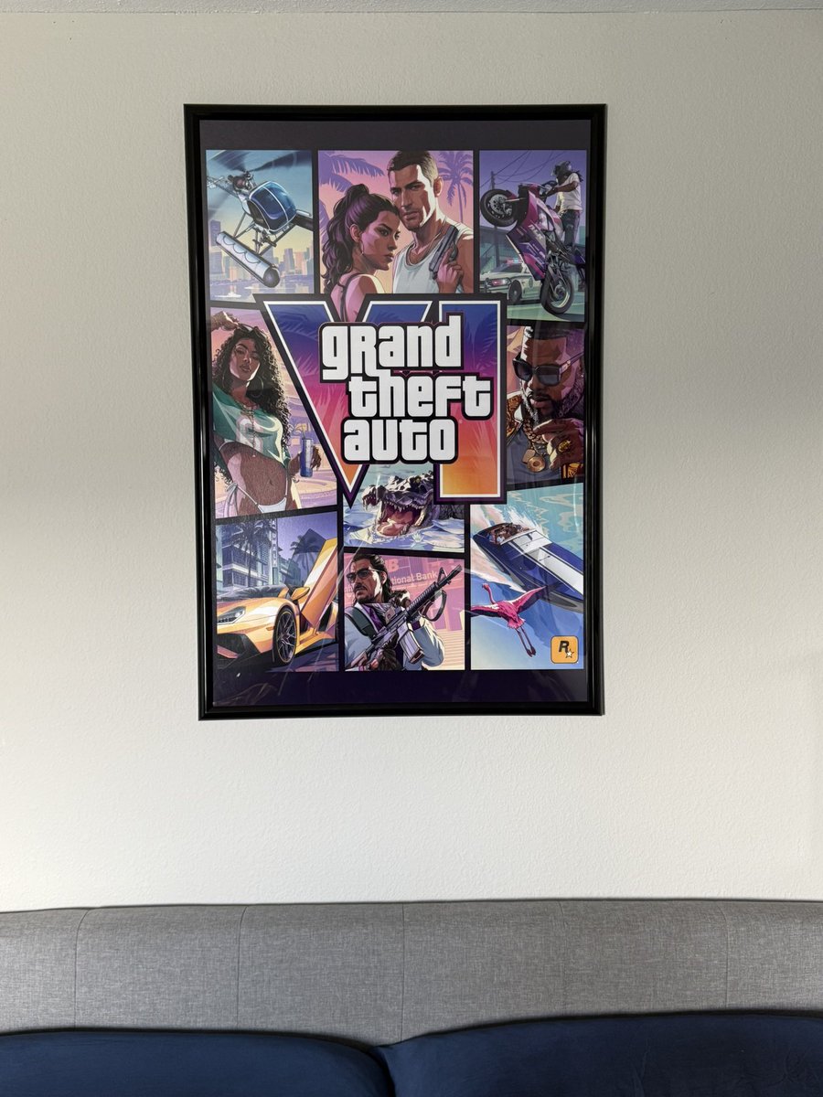 ViceMostWanted's tweet photo. finally got the GTA 6 cover art framed and hung up on my wall. 

we have to build our own hype till rockstar puts us out of our misery and drops trailer 3. 

120 days. #GTA6 #GTAVI https://t.co/kqN74SvFmo