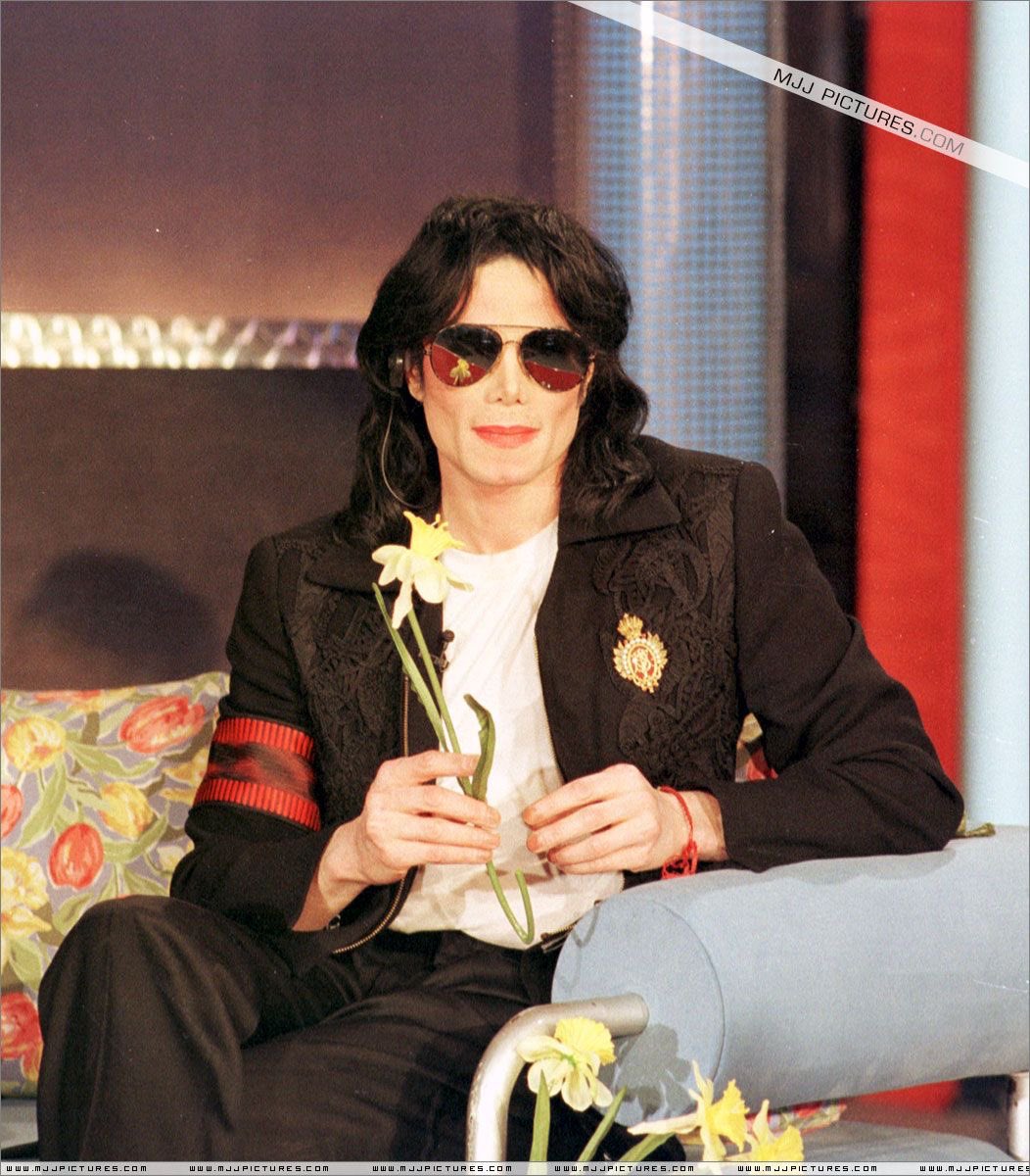 whimsichael's tweet photo. he looks so graceful here but is he sticking the flowers into the couch https://t.co/7CilZZzhx1