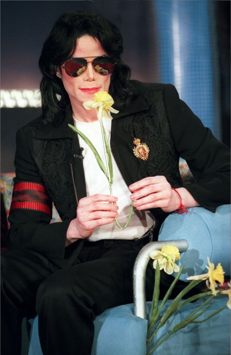 whimsichael's tweet photo. he looks so graceful here but is he sticking the flowers into the couch https://t.co/7CilZZzhx1