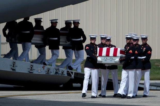 BenghaziNotes's tweet photo. On 9/14/12 at an enormous hangar at Andrews AFB in Maryland, the remains of the Americans who perished in #Benghazi arrived. Emerging from a C-17 cargo plane, six Marines each carried the flag-draped caskets of the fallen on top of stands before four waiting hearses, as a color guard led the somber procession. Present at the ceremony to receive the remains were @BarackObama, @HillaryClinton and Leon Panetta, who had abandoned Americans in #Benghazi 3 days before. They were now tasked with pretending they valued the lives of the fallen more than their 2012 political ambitions.