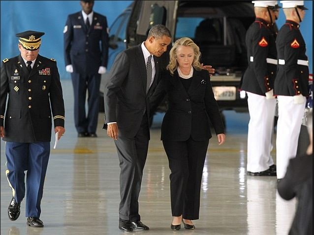 BenghaziNotes's tweet photo. On 9/14/12 at an enormous hangar at Andrews AFB in Maryland, the remains of the Americans who perished in #Benghazi arrived. Emerging from a C-17 cargo plane, six Marines each carried the flag-draped caskets of the fallen on top of stands before four waiting hearses, as a color guard led the somber procession. Present at the ceremony to receive the remains were @BarackObama, @HillaryClinton and Leon Panetta, who had abandoned Americans in #Benghazi 3 days before. They were now tasked with pretending they valued the lives of the fallen more than their 2012 political ambitions.