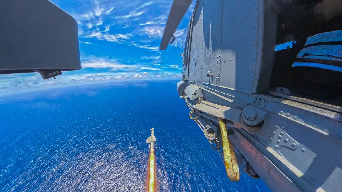 NZ_Trav's tweet photo. Royal New Zealand Navy 🇳🇿 FB post:

Missile away 🎯 HMNZS Te Mana’s Seasprite helicopter recently conducted a successful anti-ship guided missile launch against a target vessel.

Travelling at high subsonic speed and packing a 120kg warhead, the Penguin missile slammed into the hull of the US Navy's decommissioned amphibious assault ship USS Peleliu in deep waters off Hawaii during Exercise RIMPAC.

As intended, the missile detonated inside the vessel inflicting significant damage compromising the ships integrity. 

A number of navies participated in this Sinking Exercise (SINKEX) designed to test airborne and shipborne munitions against seagoing threats.

#RIMPAC2026
