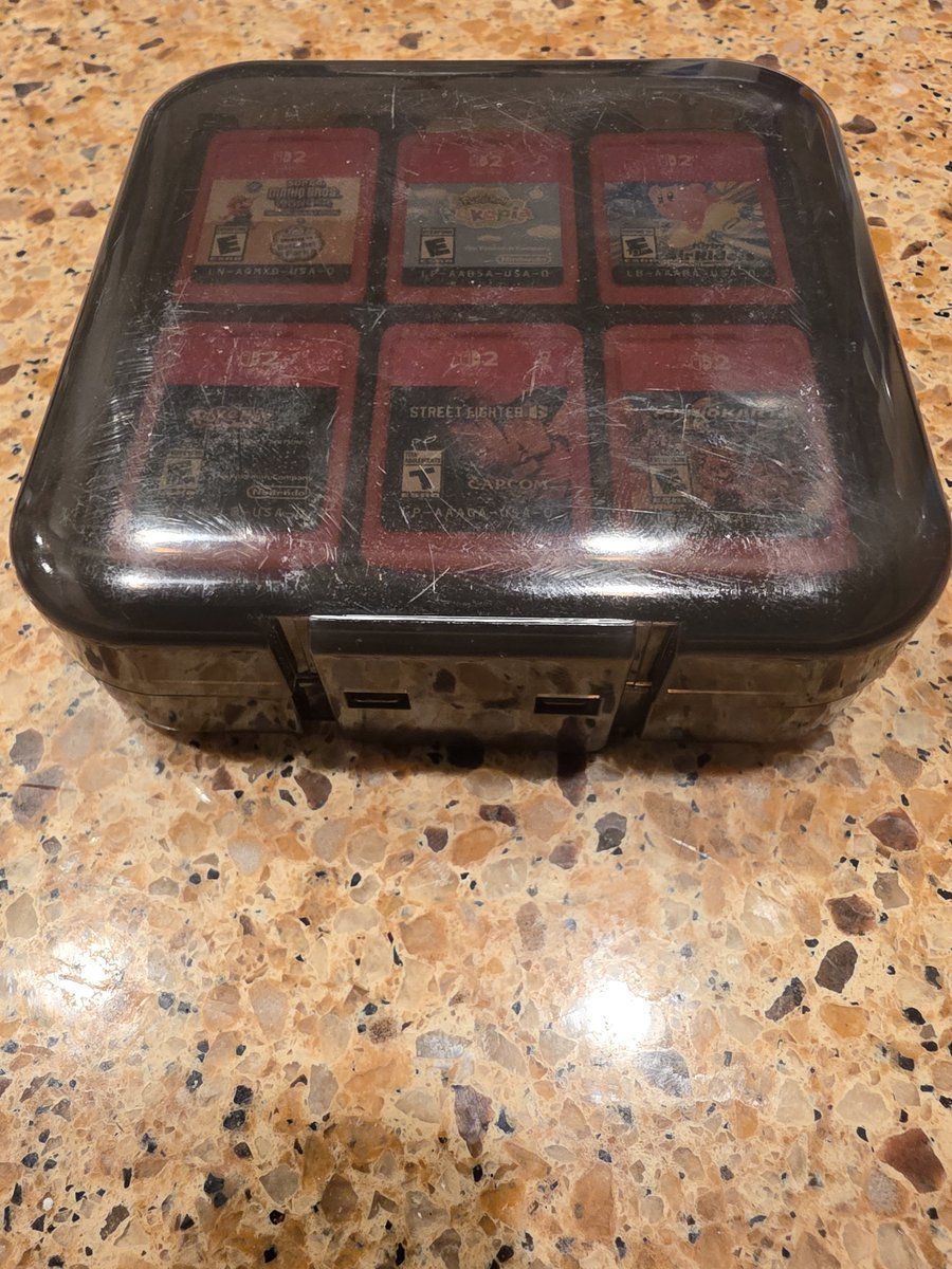 MiggySoCal's tweet photo. @Nintendeal Roughed up but a good amazon basics switch game case for up to 24 cartridges https://t.co/3K1mTCWlva