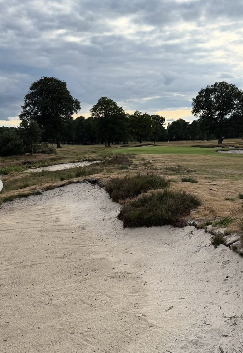 MoortownGC's tweet photo. How Moortown's 5th became a very different and significantly better test

Five years ago Moortown's 5th hole underwent some sweeping changes and today it sits as one of the strongest holes on the course. It remains a risk-reward par 4 but it now appears and plays very different to in years gone by. 

Architect Clyde Johnson oversaw the changes and he would carry out much of the work himself. 

"This was almost universally recognised as unsatisfactory among the membership. This pocket of the course had been changed quite a bit from back in the MacKenzie day, with the 5th originally a hard dogleg to the left around a copse of trees. The original intention was to reward the golfer who could hook one against the camber to leave an open angle to the green, which was protected by a large, artful bunker to its front right.

"A pair of new holes, at 6 and 7, were added by Donald Steel in the last century. But, with much-needed tree removal to integrate those into the remainder of the course, the 5th opened up a more direct line of play. With this came the opportunity to create a tempting and teasing short 4 for the better player while restoring MacKenzie’s strategy. The two fairway bunkers, which had been added to the outside of the hole, were superfluous to the original strategy. Allowing the ball to run out to leave a bad angle was more than enough, especially as you were never going to be able to see those bunkers unless you unnaturally jacked them up."

Previously you would be unable to make out where your tee shot had finished, now it is a very different looking hole.

"The ditch that runs down the left is beautiful so we have tried to take advantage of that and encourage people to take on the green. Three bunkers, sat naturally into the face of the bank, charm the golfer towards the direct line which is a more onerous carry than it appears. It’s hard not to resist playing a tighter line and we’ve hopefully ended up with a pretty playful short 4. 

"We also restored the back bunker, a classic MacKenzie feature, which is staggered deceptively beyond the new drive bunkers. When approaching the green from the fairway, this bunker seemingly sits beyond the huge, restored front-right bunker."

Martin Heggie has seen the course evolve since taking over as Moortown's Head Professional in 2003 and the 5th stands out as one of the highlights in terms of moving things to another level.

"No hole has changed more dramatically in my time here. The tee shot now is totally unrecognisable with the removal of the trees and then Clyde Johnson came in and transformed it alongside our greenkeeping team.

"You now have a proper decision to make off the tee. It used to be much more of a dogleg, now it’s more a case of how much you dare to bite off. From the yellow tees, if you can send it 240 yards, you will have a chance of making the green. It has also opened up things visually as you can now see more of where your ball’s landing whereas previously this was a lot harder to pick out with any certainty.

"Greenside it just used to be surrounded by trees and some poor bunkering. The 5th was historically probably one of the weakest holes, now it’s become one of the strongest."