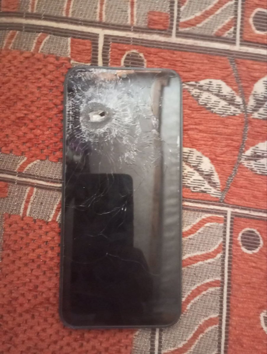Abdullah_Om3r03's tweet photo. Ahmed Abu Abdullah recounts the final moments of his daughter's life:

"A cruel piece of shrapnel... My daughter's last words to me were: 'Dad, please charge my phone. I have a study program after dinner.'

Moments later, that same piece of shrapnel pierced the phone and then struck my innocent, angelic little girl's face, ending her life after 13 days of suffering.

It shattered my heart. This is a tragedy I can neither bear nor ever forget. That phone became her final stop in this fleeting world."