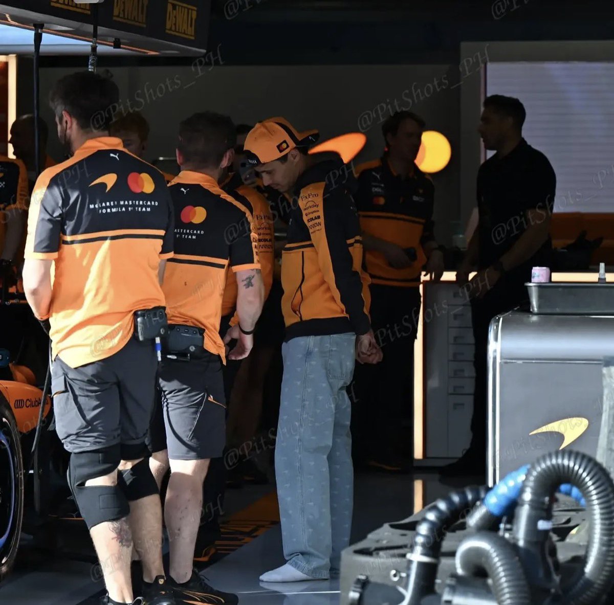 ln4norris's tweet photo. lando in socks during his visit to the garage 😭 https://t.co/YHPWFXnb4i