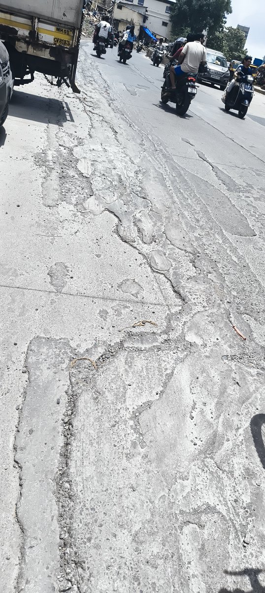 Benant's tweet photo. @mybmcWardS concrete road built at Janta Market Road Bhandup West..but no one cares to remove these patches which are causing difficulty to motorists  @mybmcroads @roadsofmumbai https://t.co/hVA9ixDO2S