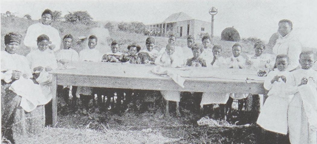 HistorySAZAR's tweet photo. One of Nokutela Dube’s early needlework classes at Ohlange; she is standing on the right, c 1901. Source: The First President by Heather Hughes https://t.co/DtAJ4vctVb
