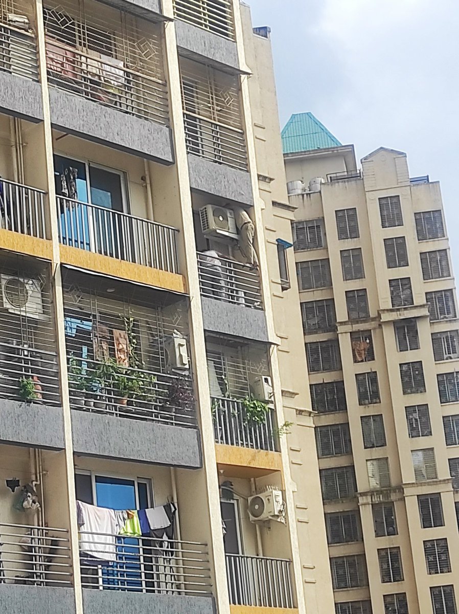 SThreadstar's tweet photo. the guy in front of my building risked his life to install an AC unit. He was on the 8th floor, standing on a thin grill without a proper safety harness or rope; only one man was holding his belt. Salute to the courage of this guy who is doing this job for his living 🫡 https://t.co/y7ERljX0M2