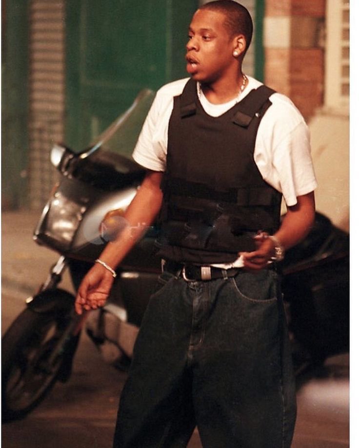 HipHop4Everyone's tweet photo. Jay-Z brought back the white tee and bullet proof vest from the Streets Is Watching (1997) music video. A billionaire who never forgot his roots 💎 https://t.co/XgUcOSCMVB