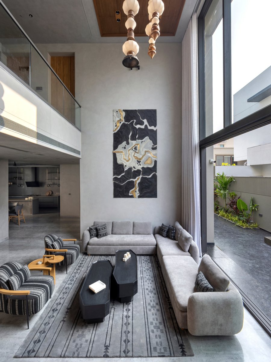 justadd2cart's tweet photo. Anirudh Residence by a+t associates a+t associates in Vadodara is a 9,000 sq. ft. home that blends contemporary living with warmth and craftsmanship. Designed around openness, natural light, and tactile materials, the home lets architecture shape the interiors.

Double-height living spaces form the heart of the residence, while carved wooden ceilings, geometric metal screens, a sculptural staircase, and handcrafted details bring depth and character. The earthy palette of wood, lime plaster, stone, and muted neutrals creates a calm backdrop for art and family life. From the striking artwork and hanging light installation to the playful children’s room, every space feels thoughtful, functional, and expressive.

See more from the source here: 
https://t.co/gttgPSZUfc

#VadodaraInteriors #AplusTAssociates #ContemporaryHome #IndianArchitecture #InteriorDesignIndia