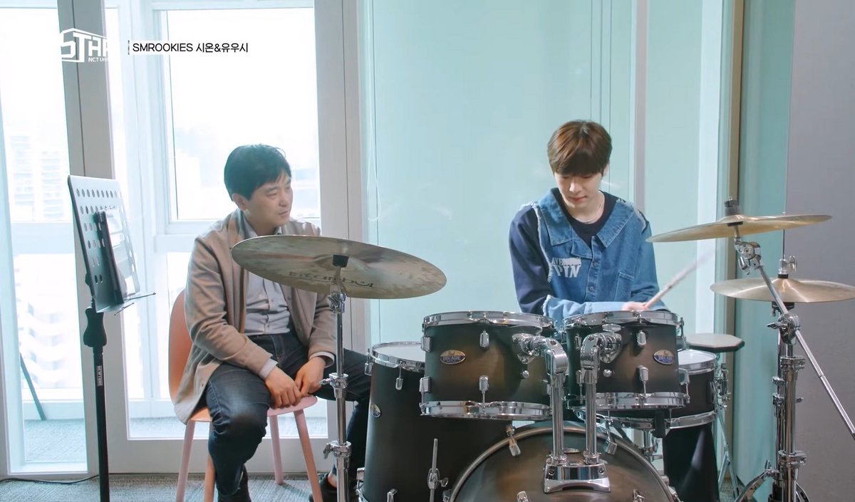 seeonocean_'s tweet photo. Drum instructor Choi Kiwoong, who also appeared on lastart with Sion, shared a post featuring nct wish's mv at kwangya 🥁

💬 I'm so grateful that all of the students I used to teach has successfully debuted, so I visited SM after a long time.
Seeing so many international fans taking photos near Seoul Forest and the company lobby really made me realize all over again just how huge Kpop has become.
Whenever I talk to students in the university's practical music program, I always tell them how tough and competitive life is for idol trainees.
The kids I taught were just 16 to 19 years old. Watching them practice so passionately while competing every single day, I feel like the success and global reputation of Korean music today is the result of all that hard work. 
I don't know when the current students I'm teaching drums will make their debut and get to show fans their amazing drumming. But I'll keep making my lessons enjoyable, knowing I'm helping Kpop in my own little way ㅎㅎ