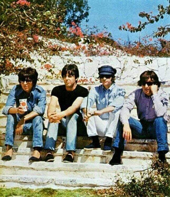 crockpics's tweet photo. The Beatles taking a sun-soaked break on the steps in the Bahamas during the filming of 'Help!', early 1965. A casual look at George, Paul, Ringo, and John escaping the British winter to make cinema history, captured by Robert Freeman. 

Robert Freeman traveled with the Fab Four to New Providence Island in Nassau after they arrived in late February 1965 to begin filming their second feature movie, Help!. Director Richard Lester wanted a colorful, exotic backdrop for the new film, and the band was more than happy to escape the biting British winter for a few weeks. 

Do we have any longtime Beatles fans who still love watching the Help! movie?👇️