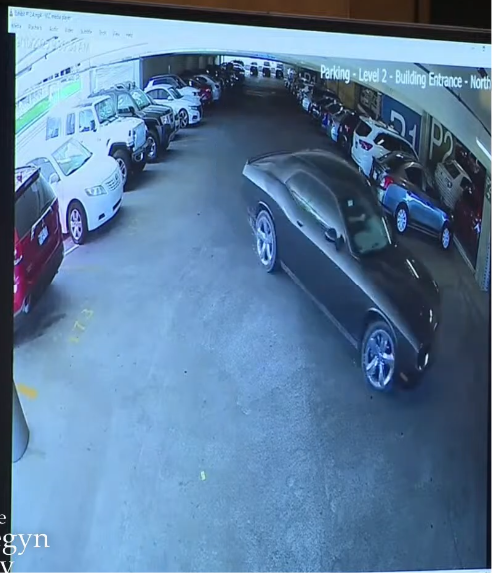 TekbotzLBC's tweet photo. 🤣smh, in that same video you will see the entire front lip disappear as he turns the corner. Did it fall off? 🤣 

No it didn't,  you're looking at a video of a video of a video. The angle, the dark color of the car, garage lighting, compression artifacts, motion blur and the fish eye are making it appear elongated and is the same reason why the hood vents disappear and why  the front lip disappear as the car turns the corner

Also, Agent Hull specifically states that exhibit 12.1 is not all of the video they have of Tyler at the UVU campus AND that this video, which I believe is exhibit 12.4 is not the zoomed in version. 

And just to be clear, while you're sitting here trying to force yourself to believe that this is not Tyler's car based on a single video of a video of a video, they literally have him on  multiple camera's walking around campus that day after he parked his car and before he jumped back into his car and left.