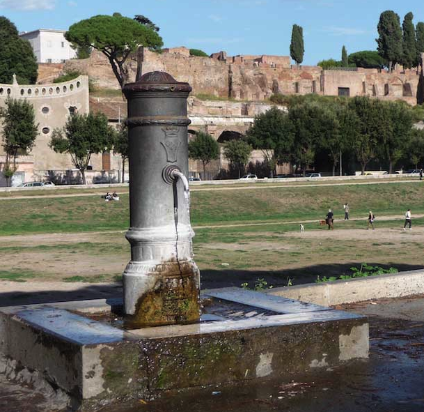 arsrocky's tweet photo. The Nasoni - supplying water in Rome since 19 BC

Visitors to Rome do not have to buy water to drink . All they need is a water bottle . Rome has about 2500 continuously running public drinking fountains on the streets, called Nasoni ,which delivers cool drinking water .

The fountains are basically cast iron cylindrical  structures containing the pipe and were introduced  by Rome's first mayor Luigi Pianciani in the 1870's. 

The water flowing to these fountains however comes through ancient routes called aqueducts, some as old as 2000 years ago .For eg If you drink from a fountain in the historical center of Rome, the water is coming directly from the Aqua Virgo aqueduct, which was built by Marcus Agrippa in 19 BC . 

There are no mechanical pumps in case you were wondering. Just Gravity and Micro-Slope. Engineers carved stone channels that decreased in elevation by  1 to 2 meters for every kilometer traveled.

When an aqueduct reached the city walls, it emptied into a massive brick distribution tower called  Castellum Aquae . From here, gravity forced the water down into a subterranean network of lead and clay pipes from where water reached the street fountains .

There is no tap for the fountain and the water flows 24/7 -that looks like a massive waste of water. But if one were to put valves or taps on all 2,500 fountains to stop when not in use, the pressure would quickly build up, bursting the vintage underground pipe network.

Continuous movement keeps the drinking water completely fresh, cool, and free from bacterial growth or stagnation.

Just to clear things up, the water isn't wasted. The overflow from the fountain drains  into Rome's underground sewer system. 

Can we do this in India ? If not the ancient way at least the modern way .

Image source for the aqueduct channel : LeoPatrizi / Getty Images