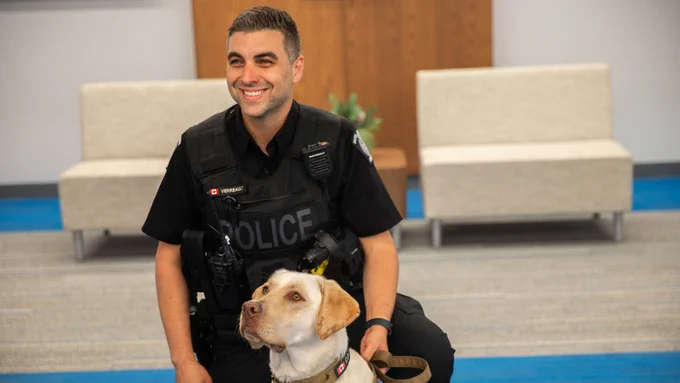 Stephane Verreault, Constable, and K9 Cache from the Halton Regional Police Service posing for a photo.