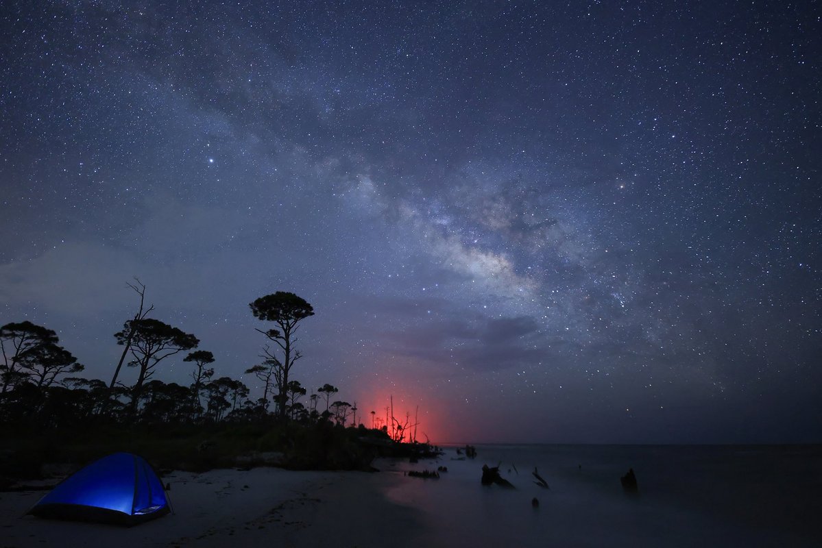 Daniel_Eidsmoe's tweet photo. I recently made a road trip to the "Forgotten Coast" and was blown away by the untouched beauty of this area in very rural Florida. The red light was the "Turtle Patrol" folks driving an ATV searching for nesting turtles. #CapeSanBlasFL #StormHour #WeatherNation #MilkyWay https://t.co/8NCZY8dRZW