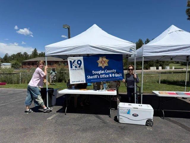 Douglas County Sheriff's Office K-9 Unit and K9 Friends banner under canopy tent