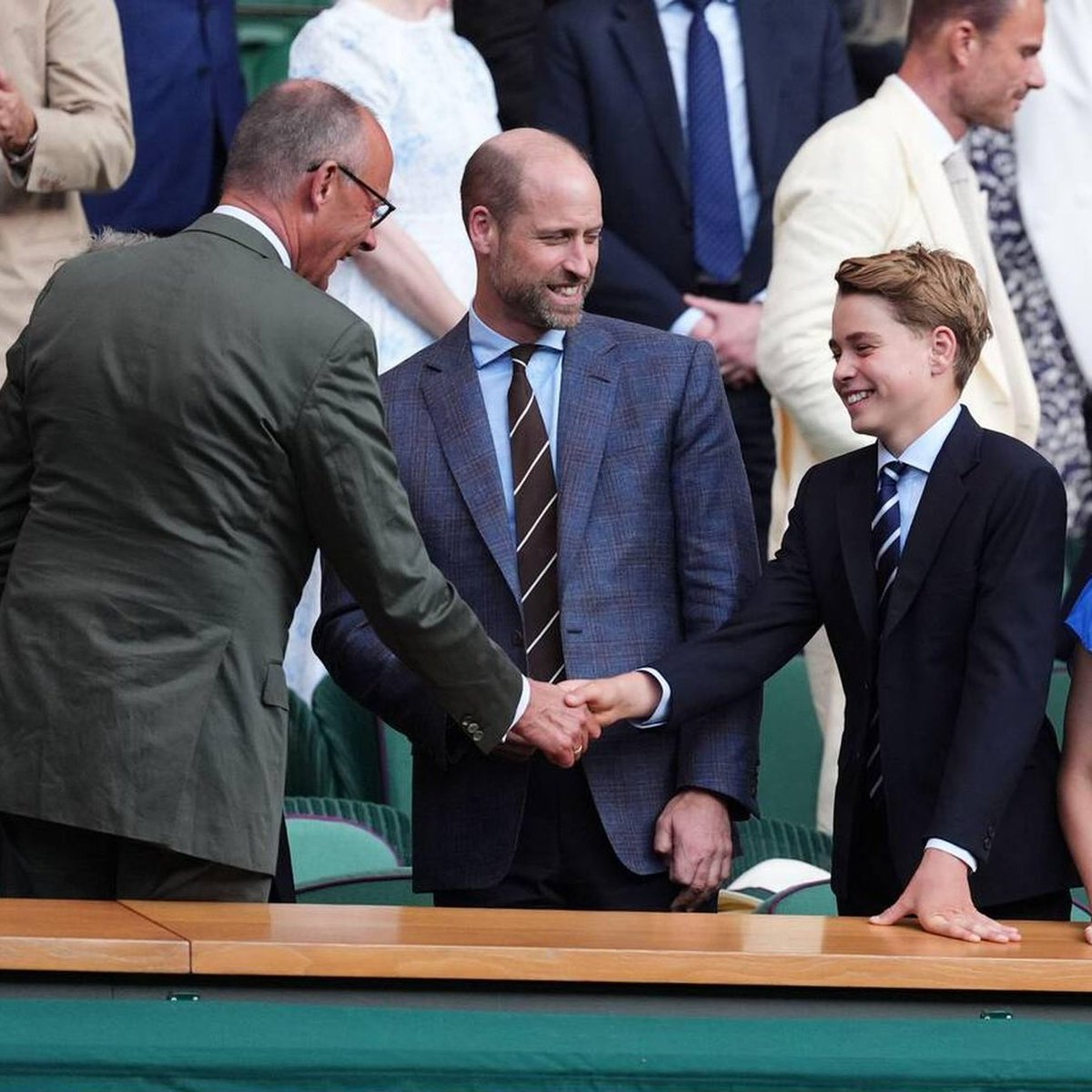 Canellelabelle's tweet photo. Prince George is merely 12 years old. Yet he holds himself with more aplomb, sophisticated class and maturity than his 42 year old uncle while meeting the German chancellor at Wimbledon over the week end🤌🏽
   George, just like William, does not need to announce himself as "Prince", you know who they are by the way they hold themselves🔥
     Harry will always need to prove he is a "Prince" because his innate vulgarity comes across as soon as you hear him or look at him.