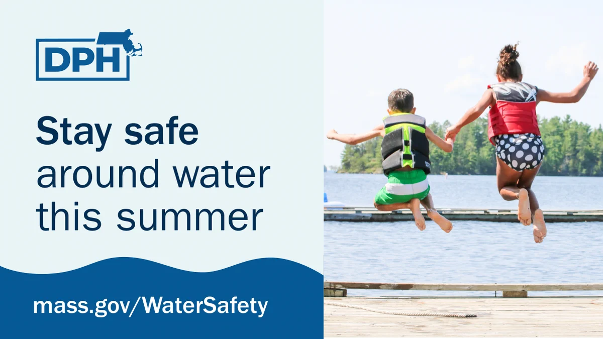 The image features a Massachusetts Department of Public Health (DPH) graphic. On the left, text reads "Stay safe around water this summer," with a link to "mass.gov/WaterSafety" below. On the right, two individuals wearing life vests are jumping into a lake from a dock.