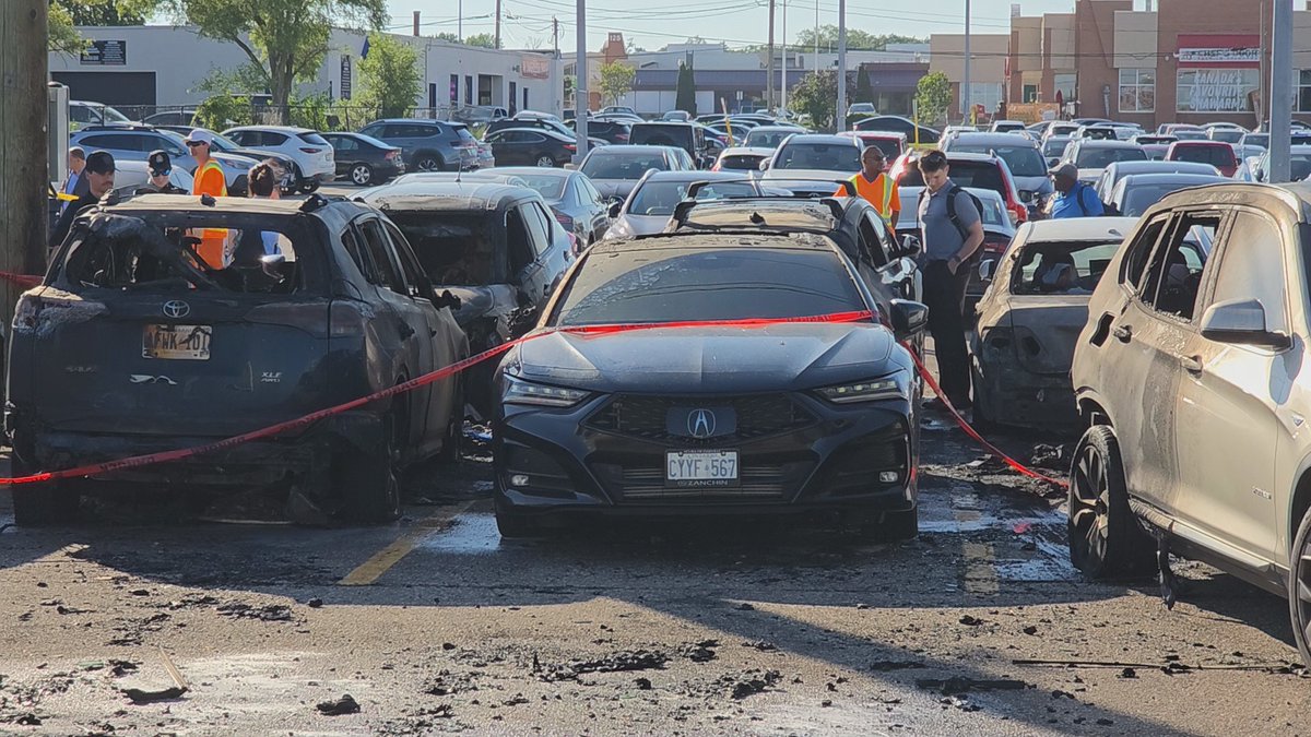 Media371's tweet photo. Six parked vehicles were destroyed after a transformer exploded on a hydro pole, sending sparks into the parking lot at the #Oakville @GOtransit station on Cross Avenue this afternoon. No injuries. https://t.co/AH1zZOv1q3