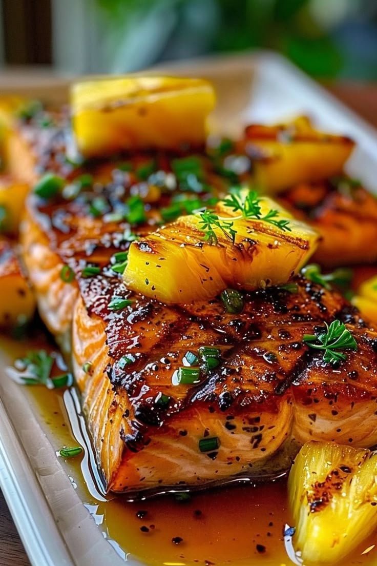 ann_ann886's tweet photo. Honey Pineapple Salmon 

Servings: 4 Prep: 10 minutes Cook: 12–15 minutes
Ingredients
4 salmon fillets (5–6 oz each), skin on or off, patted very dry
2 cups fresh pineapple chunks (plus extra rings for garnish)
2 green onions, thinly sliced
1–2 tbsp fresh parsley or cilantro, chopped (garnish)
1 tbsp neutral oil (for searing; skip if baking only)
Pinch sesame seeds (optional)
Honey‑pineapple glaze
1/3 cup pineapple juice (from the fruit or canned, not from concentrate if possible)
1/4 cup honey
2 tbsp low‑sodium soy sauce (or tamari)
1 tbsp rice vinegar or lime juice
1 tbsp brown sugar (optional for extra lacquer)
2 cloves garlic, minced
1 tsp fresh ginger, grated
1/2 tsp chili flakes or a squeeze of sriracha (optional heat)
1 tsp cornstarch mixed with 2 tsp water (slurry; for thick, glossy finish)

Method A — Skillet‑sear + oven finish 
Make the glaze: In a small saucepan, combine pineapple juice, honey, soy, vinegar/lime, brown sugar (if using), garlic, ginger, and chili. Simmer 2–3 minutes. Stir in cornstarch slurry; simmer 30–60 seconds until glossy. Remove from heat.
Prep salmon: Lightly season fillets with a pinch of salt and pepper (soy adds salt later).
Sear: Heat a large oven‑safe skillet over medium‑high. Add oil; when shimmering, place salmon flesh‑side down. Sear 2 minutes to get color, then flip skin‑side down.
Sauce + pineapple: Spoon some glaze over salmon. Scatter pineapple chunks (or a few rings) around the fish; toss them in a little glaze.
Oven finish: Transfer skillet to a 400°F (204°C) oven for 6–8 minutes, until salmon flakes easily (125–130°F for medium; 135°F for more done). Brush once more with glaze in the last minute.
Serve: Spoon pan juices over salmon. Top with green onion, herbs, and sesame seeds. Add extra pineapple on top.
Method B — Sheet‑pan (hands‑off)
Line a sheet pan with foil and lightly oil. Place salmon and pineapple; brush salmon generously with glaze. Bake at 425°F (218°C) for 9–12 minutes (thickness varies). Broil 1 minute to caramelize.
Method C — Grill
Oil grates well. Grill pineapple rings first 2–3 minutes/side to char. Grill salmon over medium‑high, skin‑side down 5–7 minutes; brush with glaze, flip 1–2 minutes to lacquer. Warm remaining glaze and spoon over to serve.
Tips for success
Dry fish = better sear and lacquer.
Don’t overcook: pull at temp; carryover heat finishes it.
Extra sticky finish: brush with hot glaze right after cooking.
No fresh pineapple? Use canned chunks in juice; use the juice for the glaze.
Serving ideas
Coconut rice or jasmine rice and steamed broccoli/asparagus
Lime wedges for squeezing
Quick cucumber salad (rice vinegar, a little sugar, sesame oil)
Quick coconut rice
Simmer 1 cup jasmine rice with 3/4 cup coconut milk + 3/4 cup water + pinch salt. Rest 10 minutes; fluff.
Make‑ahead
Glaze keeps 4–5 days refrigerated. Warm gently to loosen before using.
Enjoy the sweet‑tangy, garlicky glaze with that charred pineapple pop!
