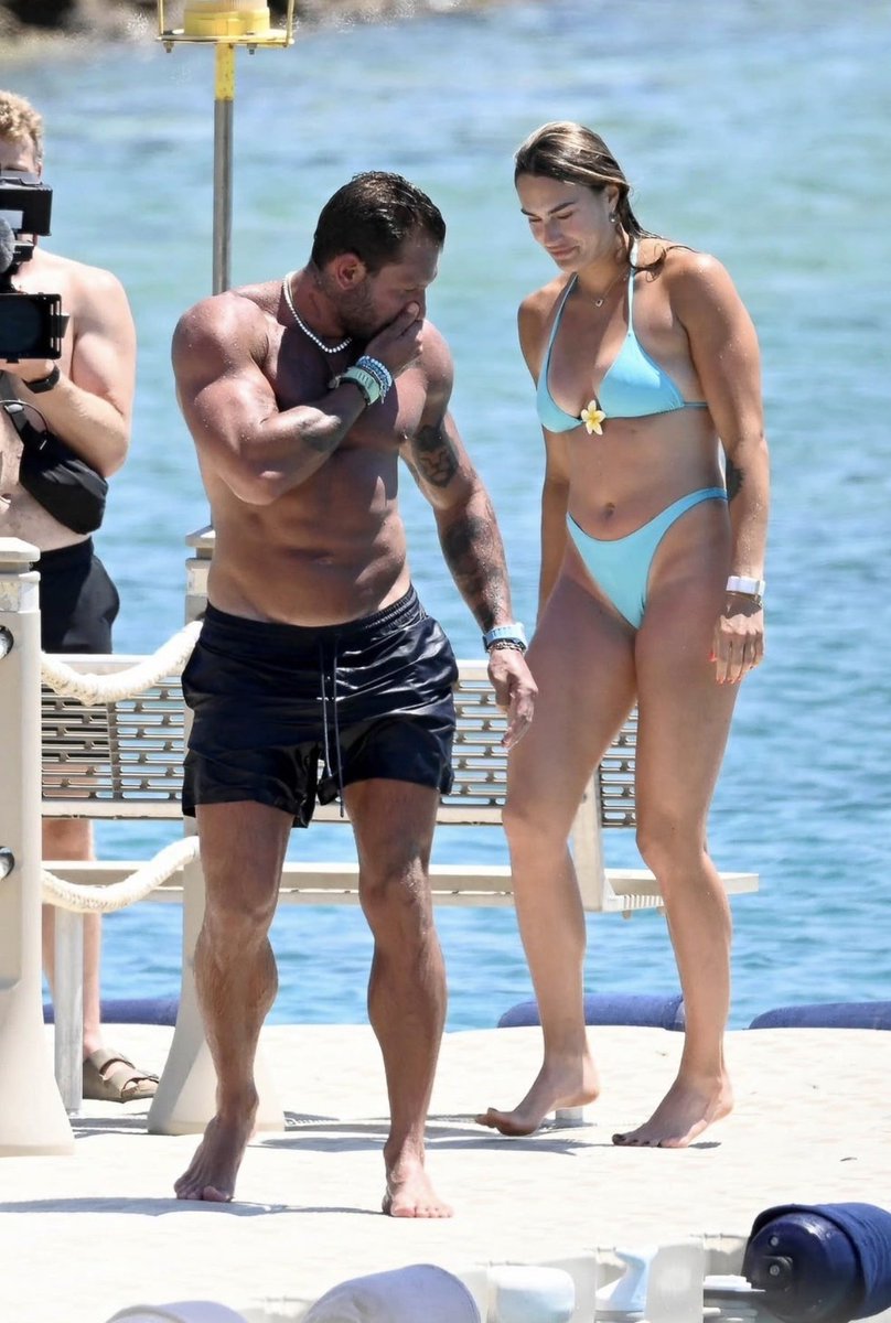 Toughtaskx's tweet photo. Tennis player Aryna Sabalenka embracing her fiancé Georgios Frangulis on a beach, 
The internet is looking at these photos twice for a reason.🥵 https://t.co/osDxkf5Sa5