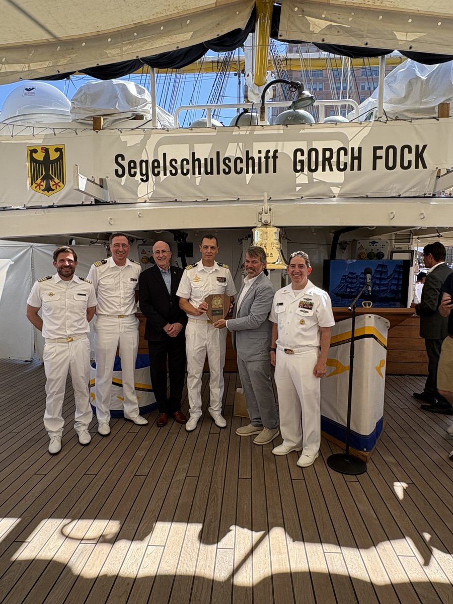 NavalWarCollege's tweet photo. U.S. Naval War College Provost, Dr. Stephen Mariano presented an NWC plaque to Capt. Elmar Bornkessel, Commanding Officer of the German Navy's Sail Training Ship Gorch Fock, July 12. The Gorch Fock was in Boston for @SailBoston2026, part of Sail 250. https://t.co/z4ZWau6rvP