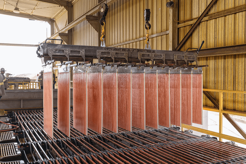 Gaurab's tweet photo. Almost half the copper the United States mines never touches a smelter. It comes out of the Arizona desert through piles of crushed rock, some of it barely half a percent copper, with sulfuric acid dripping through the top while gravity pulls the metal down over weeks. The acid dissolves it straight out of the stone into a blue solution that pools in a lined pond, and solvent extraction and electrowinning turn it into pure cathode right on site. One new Arizona project pencils out at a cash cost of $1.34 a pound, working 513 million tons of ore that averages 0.52% copper. I manufacture chemicals. The economics still catch me off guard. Ore this poor was worthless before solvent extraction scaled up in the 1980s, too lean to smelt without burning money. A lot of it just sat in waste dumps. America is down to two primary copper smelters from sixteen in 1976. Every GPU rack, motor, and transformer in the AI buildout runs on copper. The country now covers a real share of that demand by running acid through the rock it used to ignore.