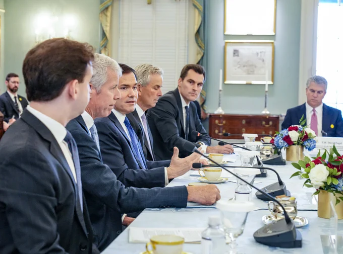 Secretary Marco Rubio delivers remarks at a meeting of the Economic Diplomacy Action Group at the Department of State in Washington, D.C., July 15, 2026. State Department/ Freddie Everett.  Secretary Rubio is seen in action while giving remarks, seated at a large square table with the action group in a conference room.  