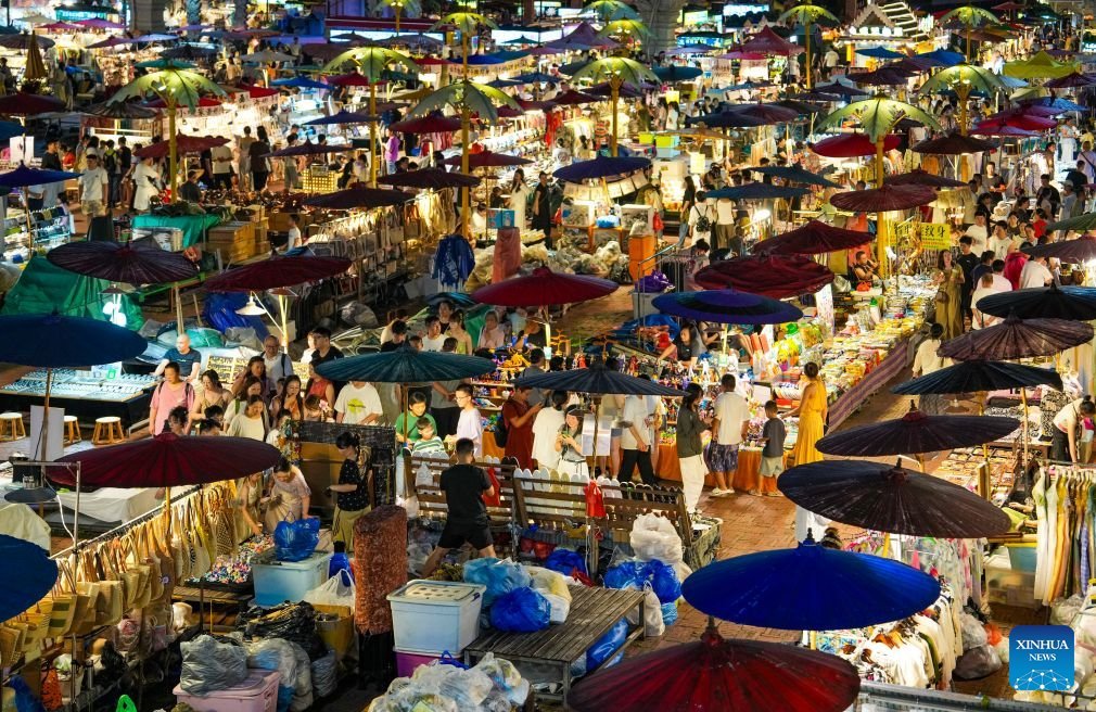 PDChina's tweet photo. The Starlight Night Market, located in Jinghong of Xishuangbanna Dai Autonomous Prefecture,  southwest China's Yunnan Province, has witnessed a surge in visitor arrivals during the summer peak tourism season. Featuring local delicacies, ethnic culture and diverse nighttime consumption options, this night market reflects the vitality of local cultural and tourism market.