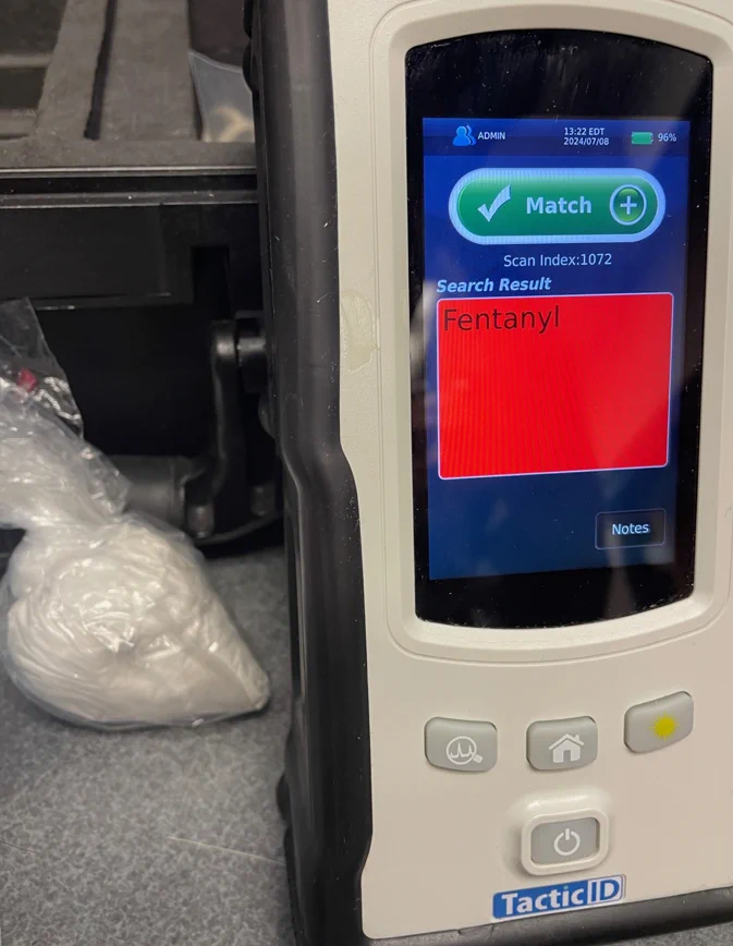 bag of fentanyl next to a digital tester with a screen lit up with the word fentanyl