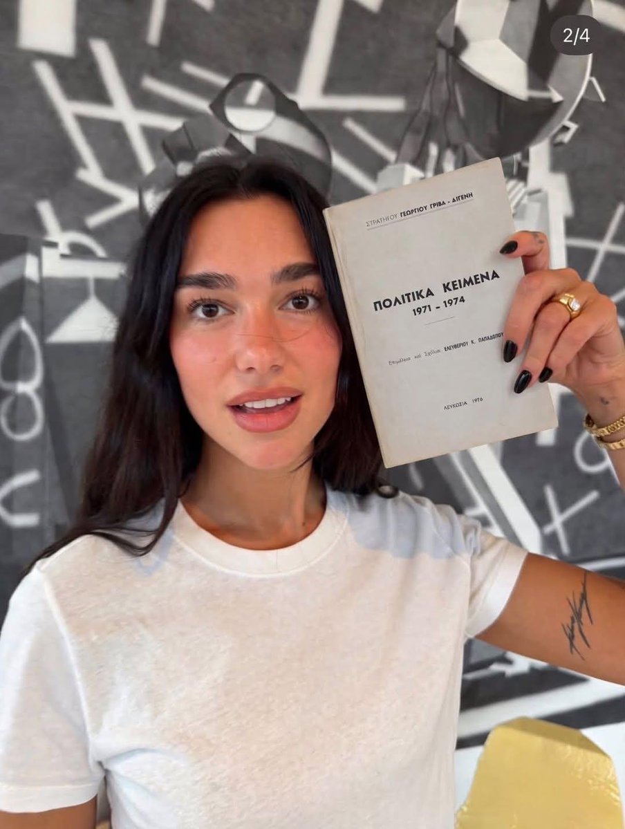 DailyTurkic's tweet photo. Dua Lipa is holding a book by Greek General Grivas that is banned in Greece because it contained plans from 1971–1974 to exterminate the Turkish Cypriot population. https://t.co/pO8QSY73s2